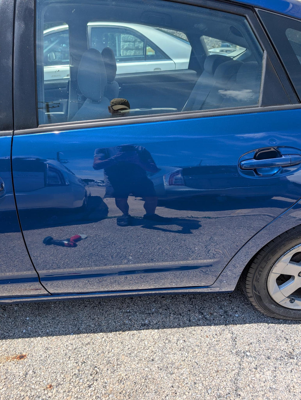 After door scuff repair on blue Prius